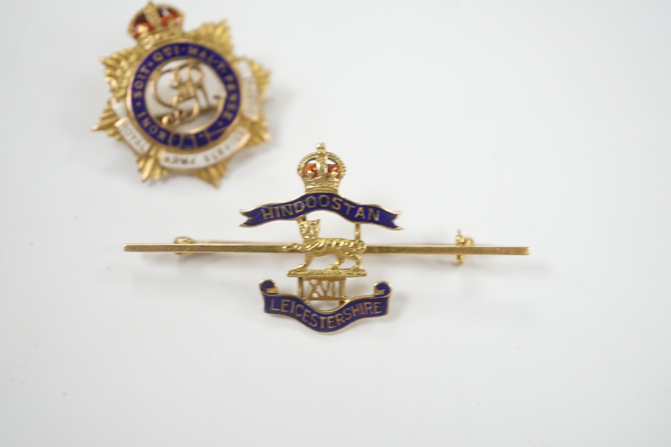 A 14ct and two colour enamel Royal Leicester Regiment sweethearts brooch, 50mm and a 9ct and enamel Royal Army Service Corps badge.